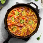 Overhead of sweet potato frittata in a black cast iron skillet.
