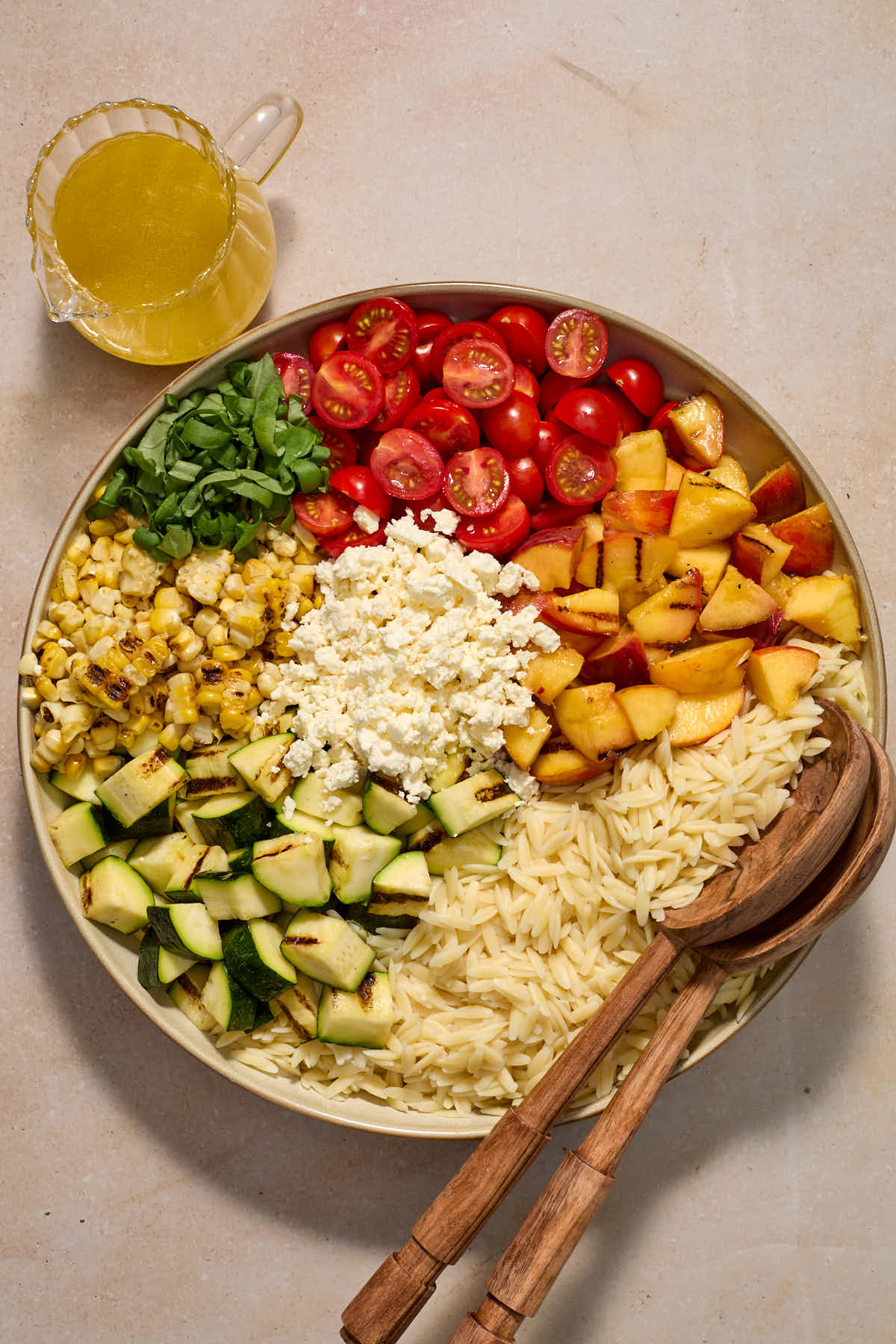 All of the salad ingredients sectioned in a large bowl with dressing on the side.