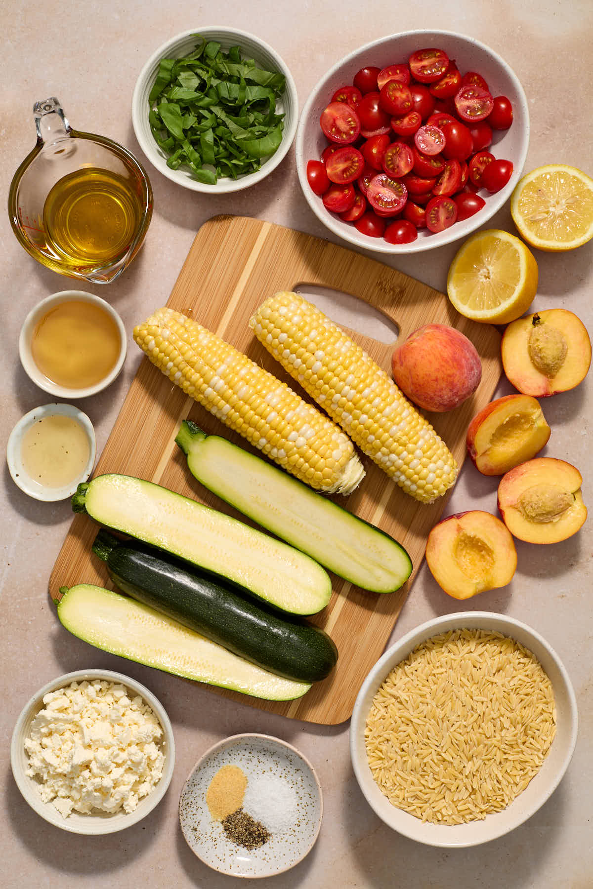 Ingredients for grilled summer vegetable orzo salad arranged individually.