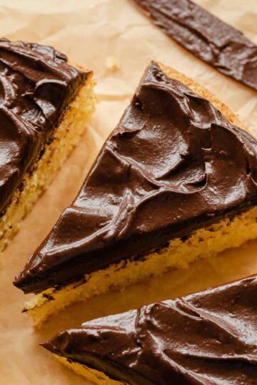 Slice of cake topped with chocolate avocado frosting.