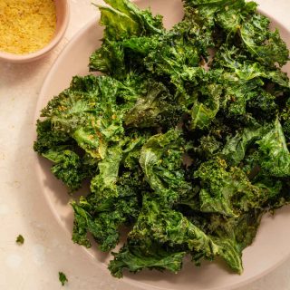 Air Fryer Kale Chips arranged on a pink plate.