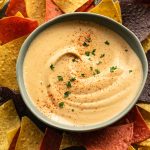 Overhead view of cashew chipotle dip in a blue bowl.