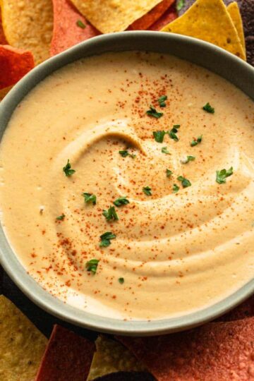 Overhead view of cashew chipotle dip in a blue bowl.