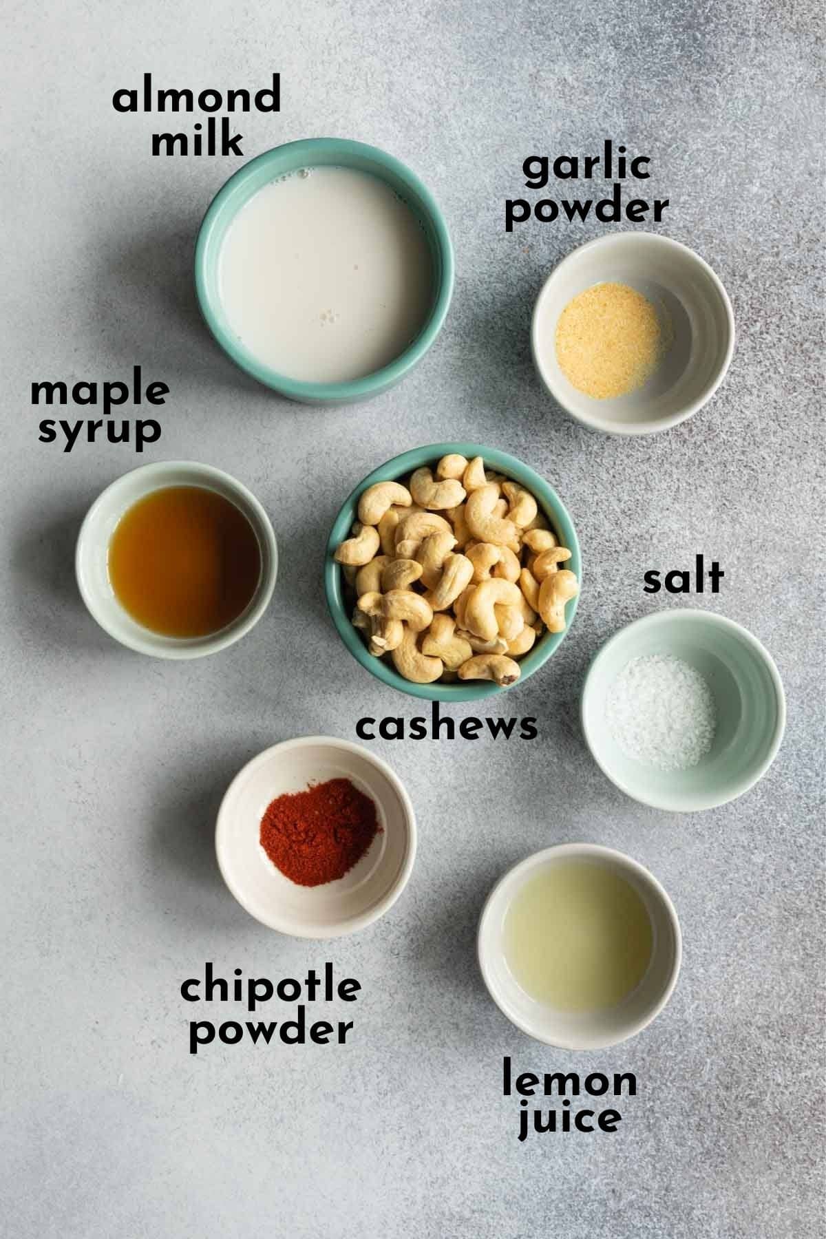 Ingredients to make vegan chipotle dip arranged individually and labelled.