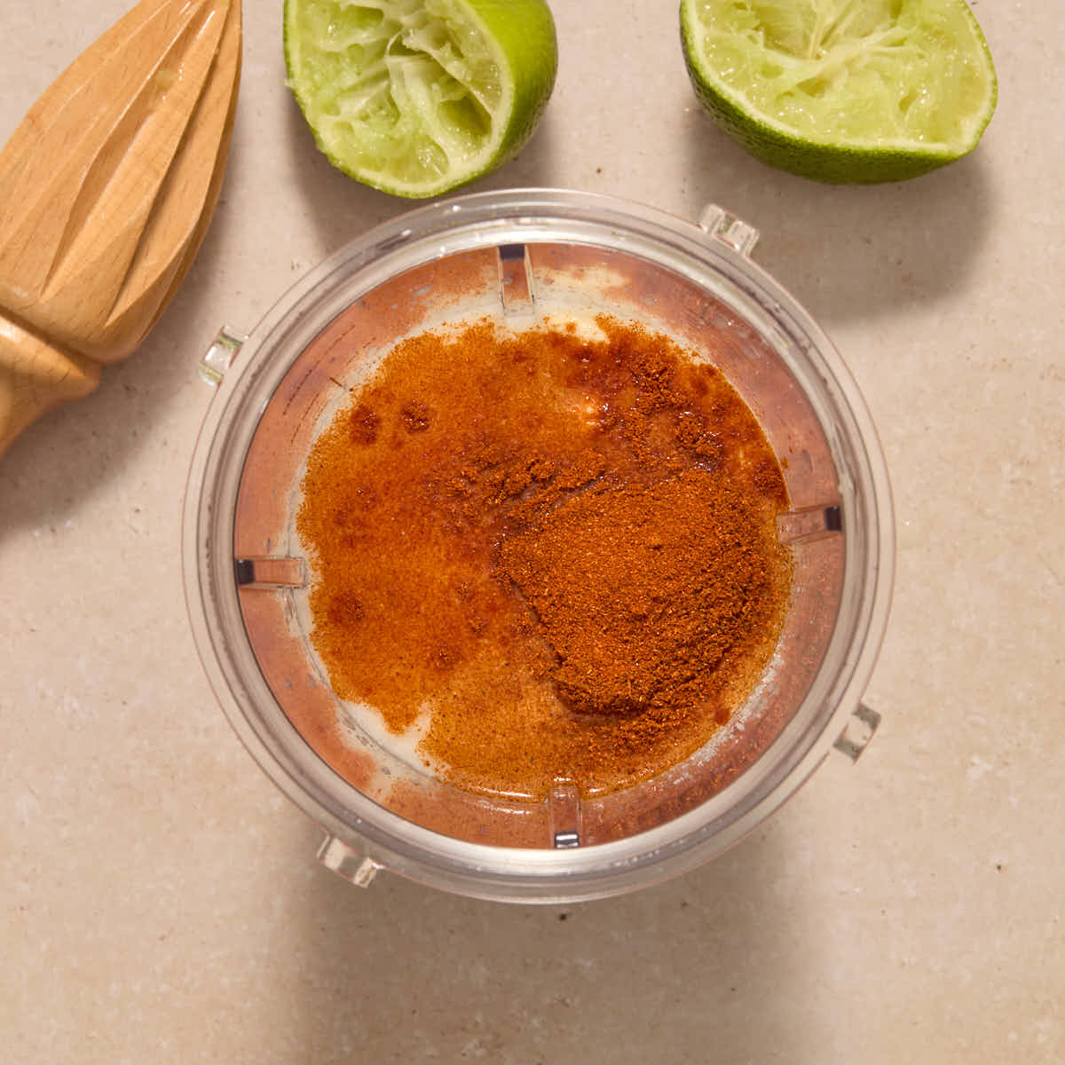 Spices and other ingredients added on top of the cashews in the smoothie cup.