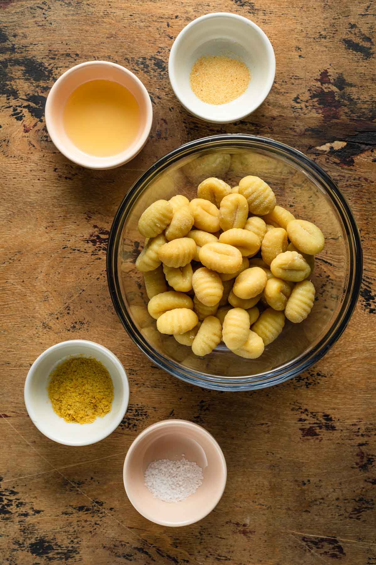 Ingredients to make air fryer gnocchi arranged in individual bowls.