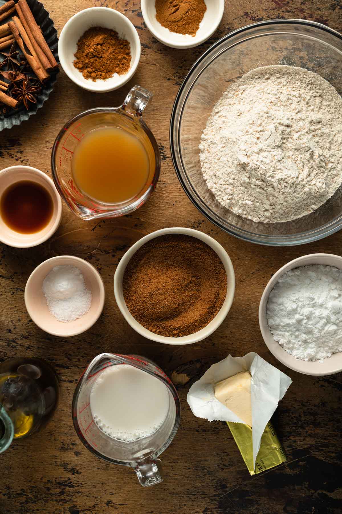 Ingredients to make apple spice cake arranged in individual bowls.