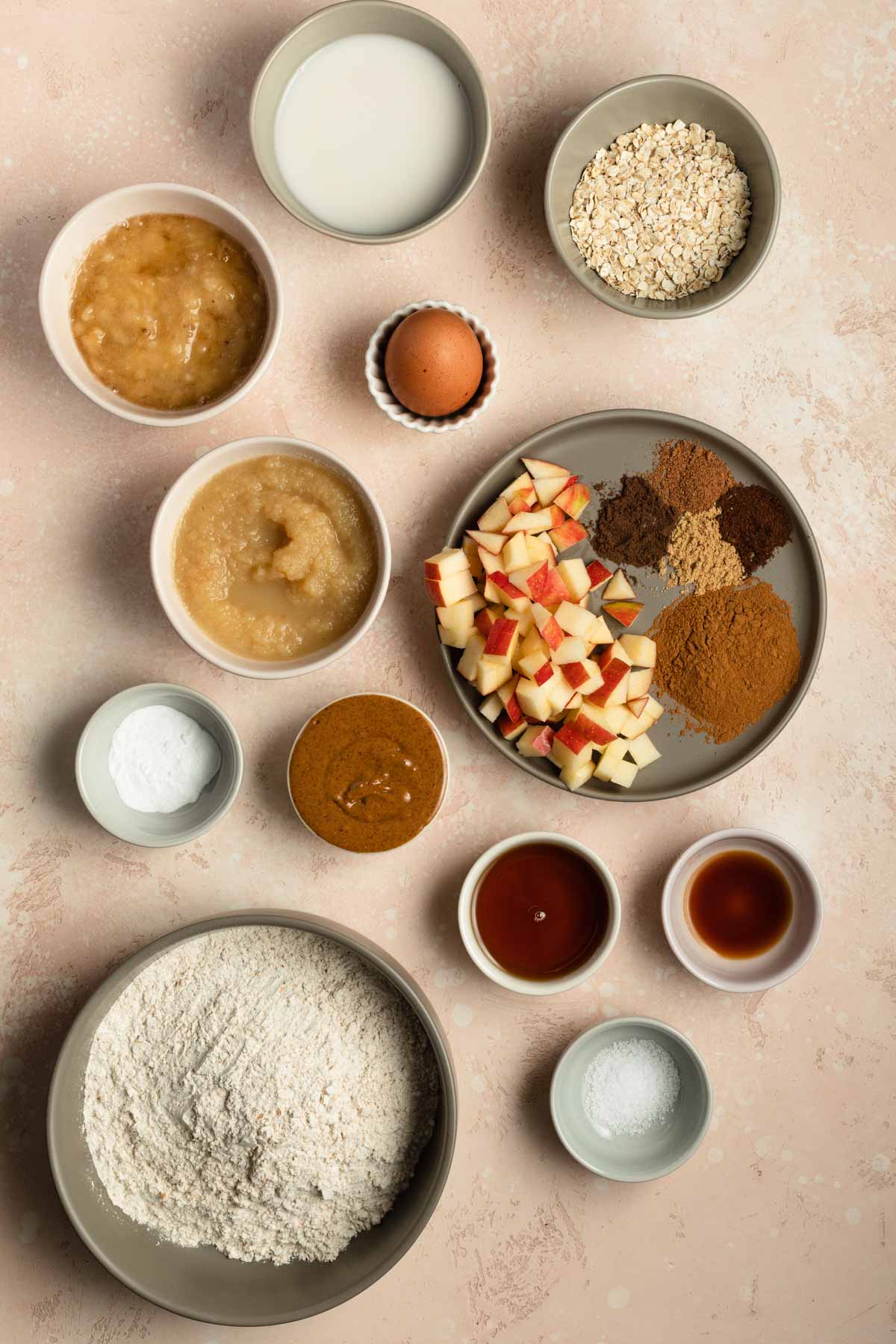 Overhead view of ingredients to make apple spice muffins arranged individually.