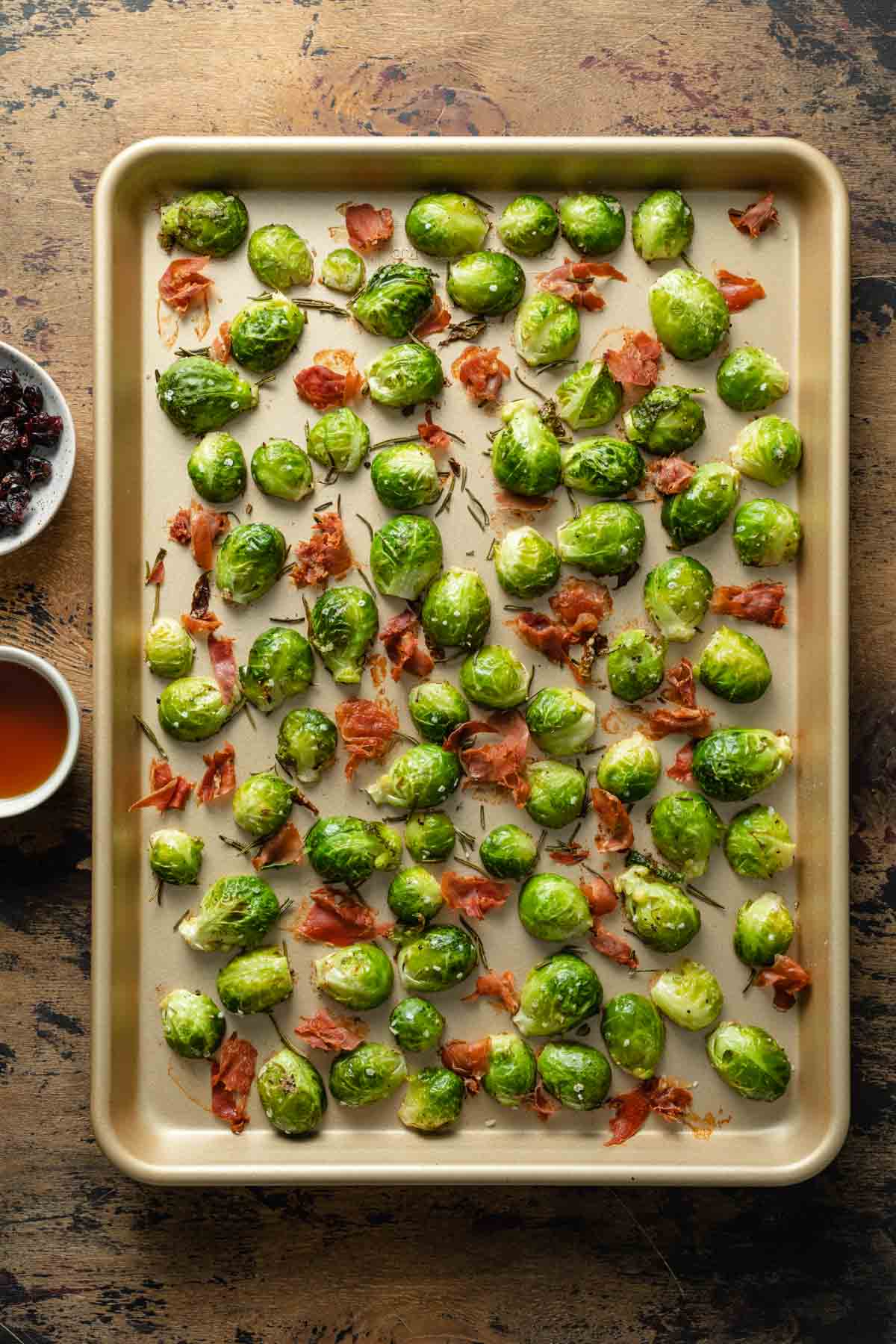 Roasted Brussels sprouts and prosciutto on a sheet pan.