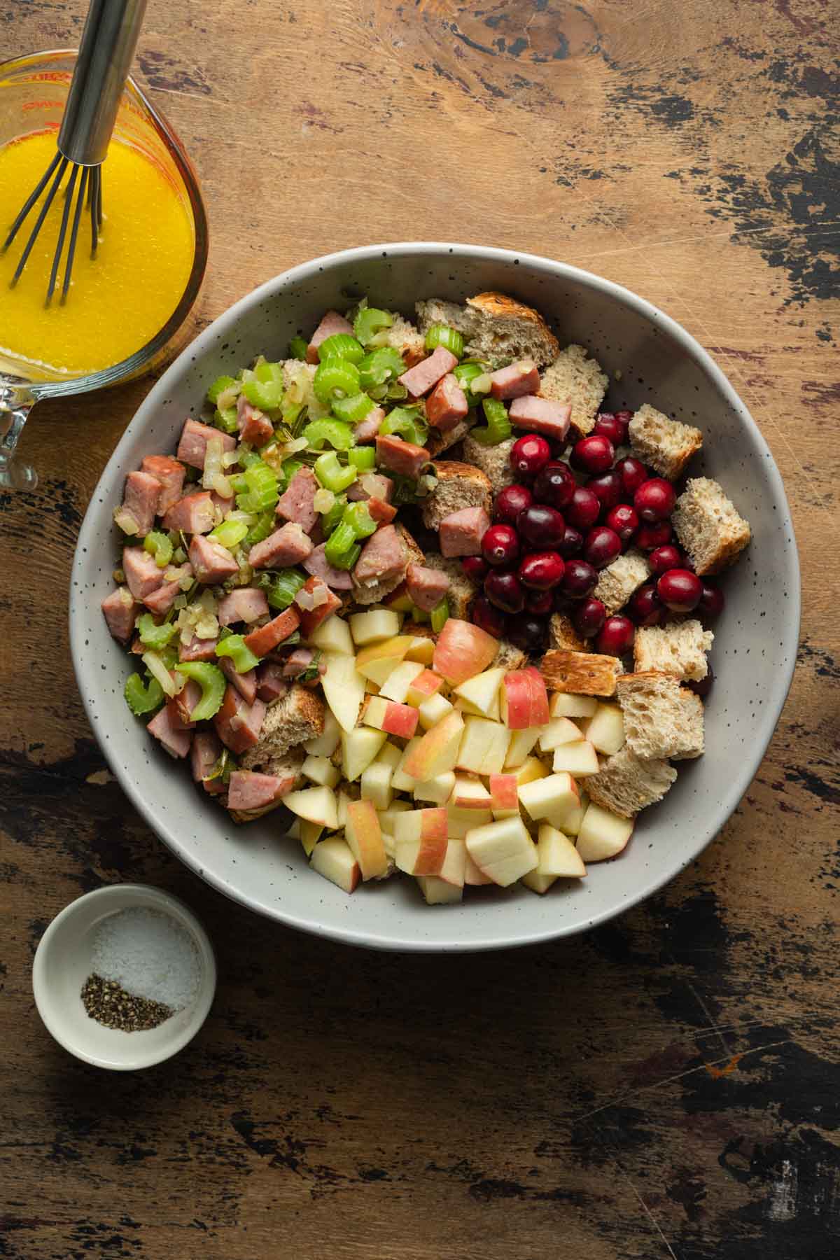 Stuffing ingredients added to a large grey bowl.