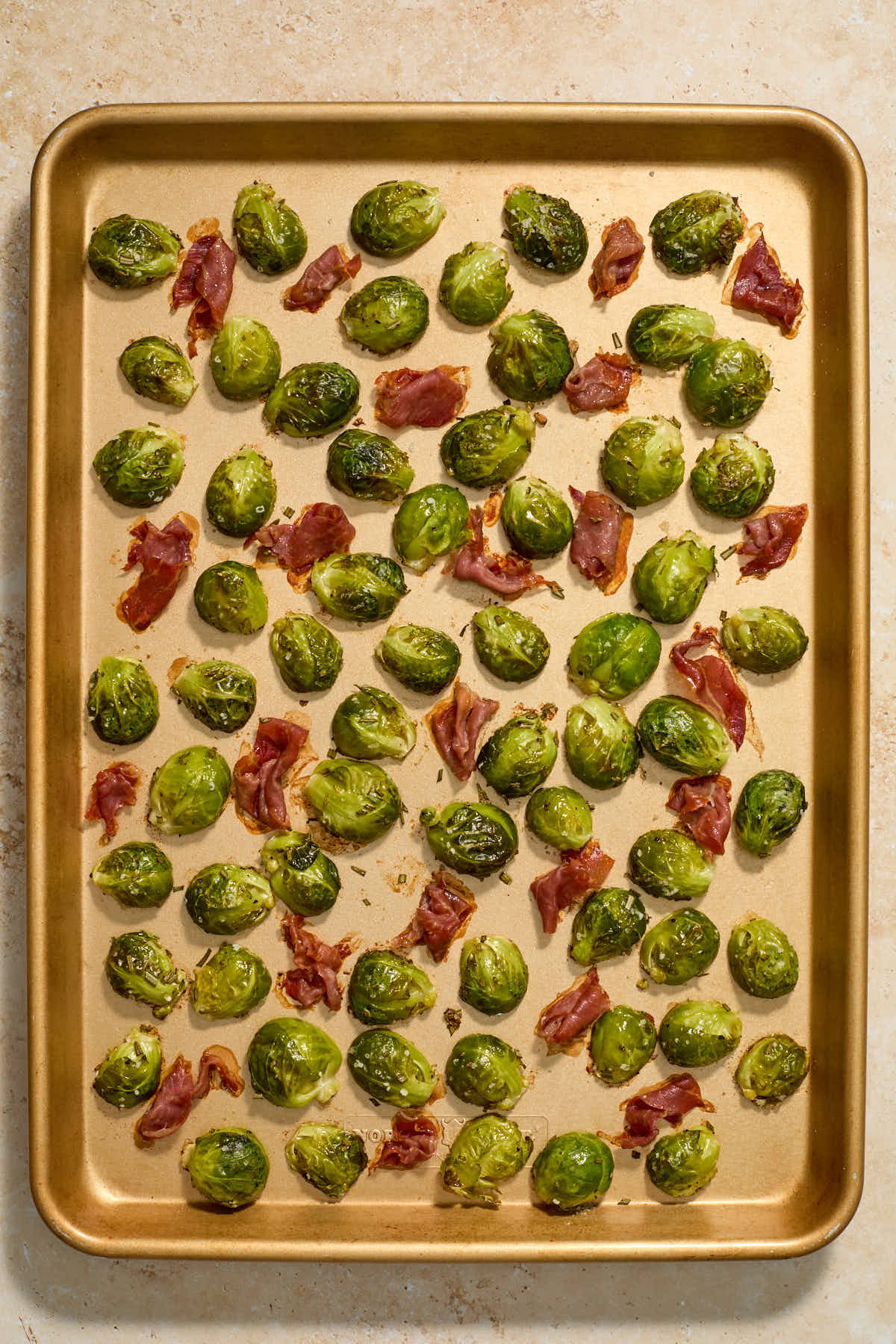 Roasted Brussels sprouts and crispy prosciutto on a sheet pan.