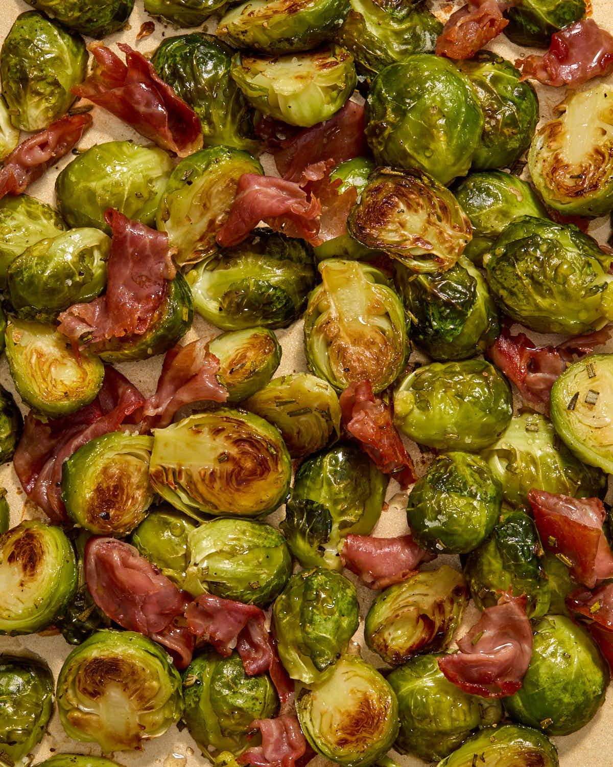 Roasted Brussels sprouts and prosciutto tossed with maple syrup.