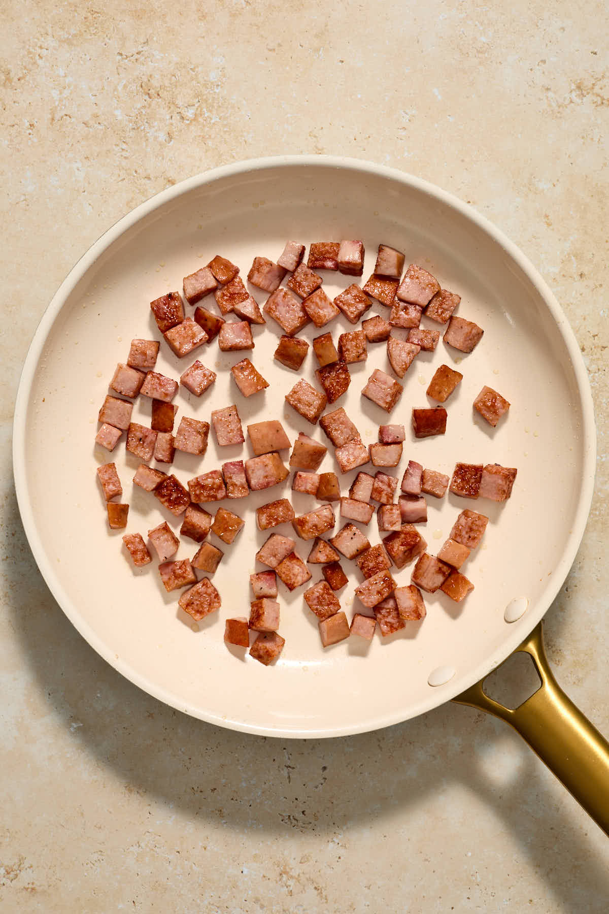 Chopped up kielbasa sausage browned in a skillet.