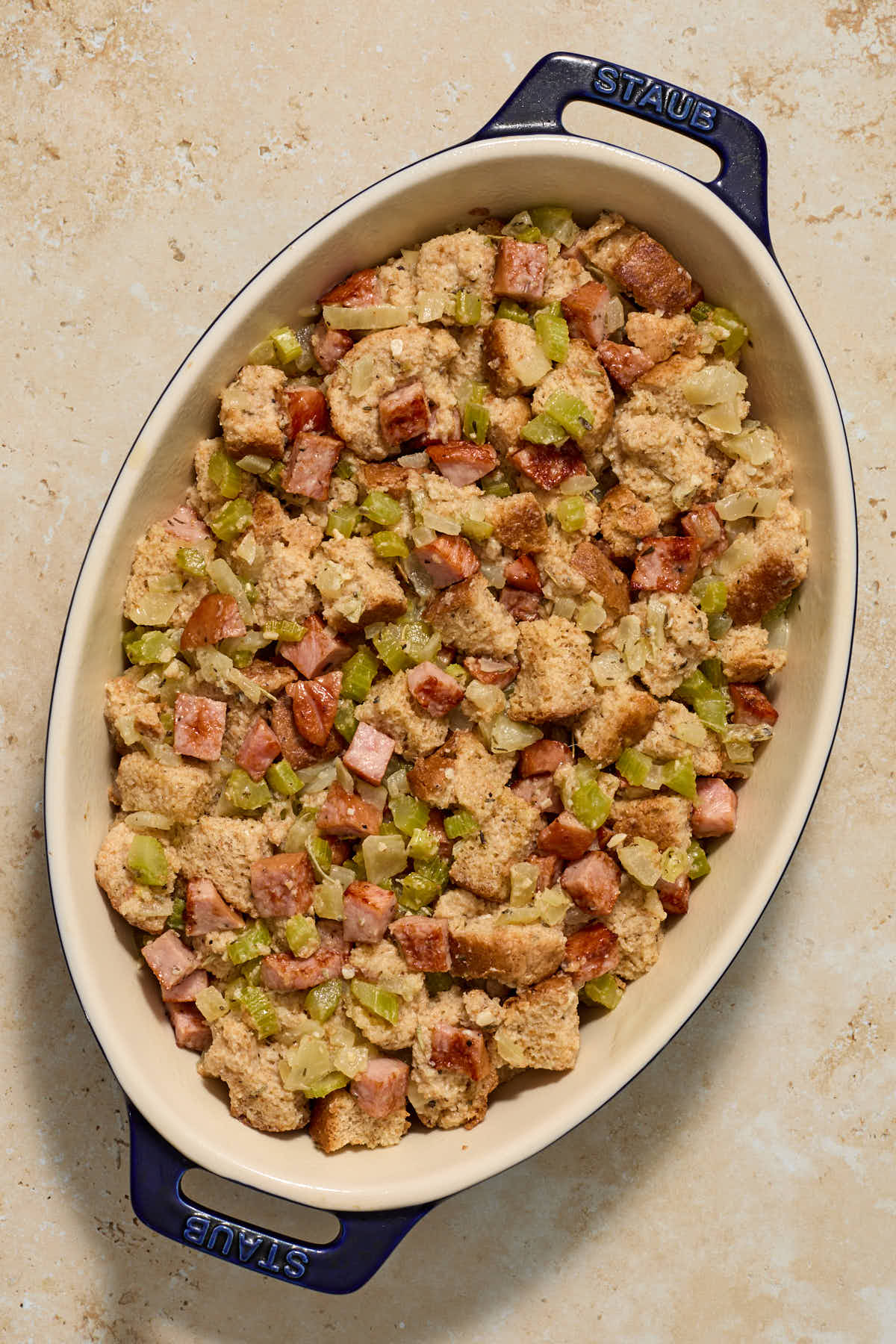 Stuffing mixed together and spread out in a baking dish.