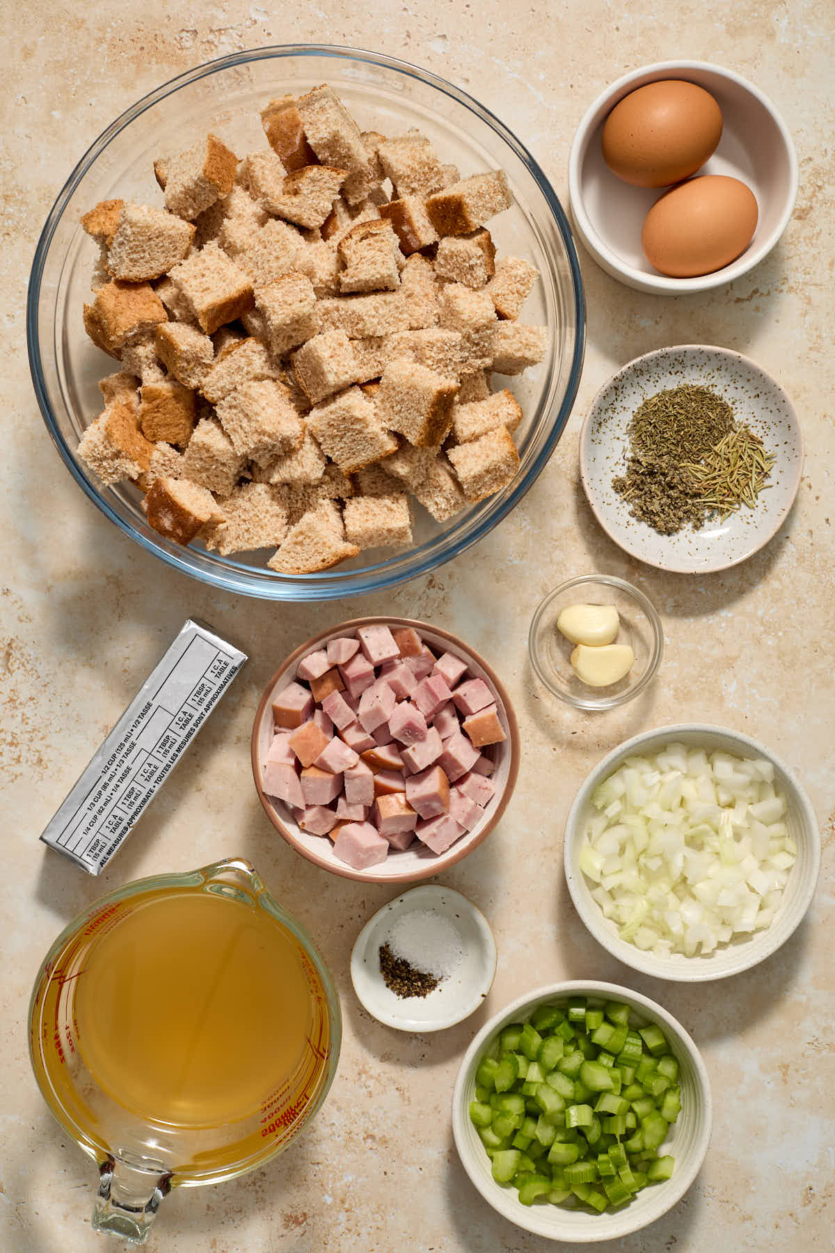 All of the ingredients to make whole wheat stuffing arranged individually.