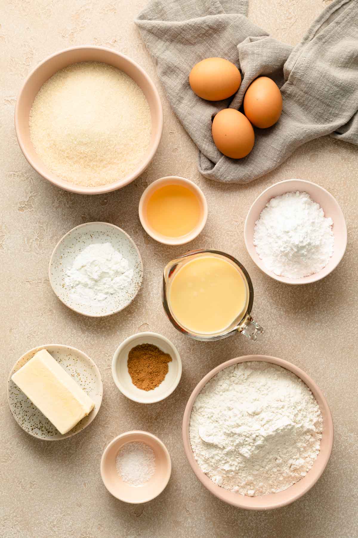 Ingredients to make eggnog bundt cake arranged individually.