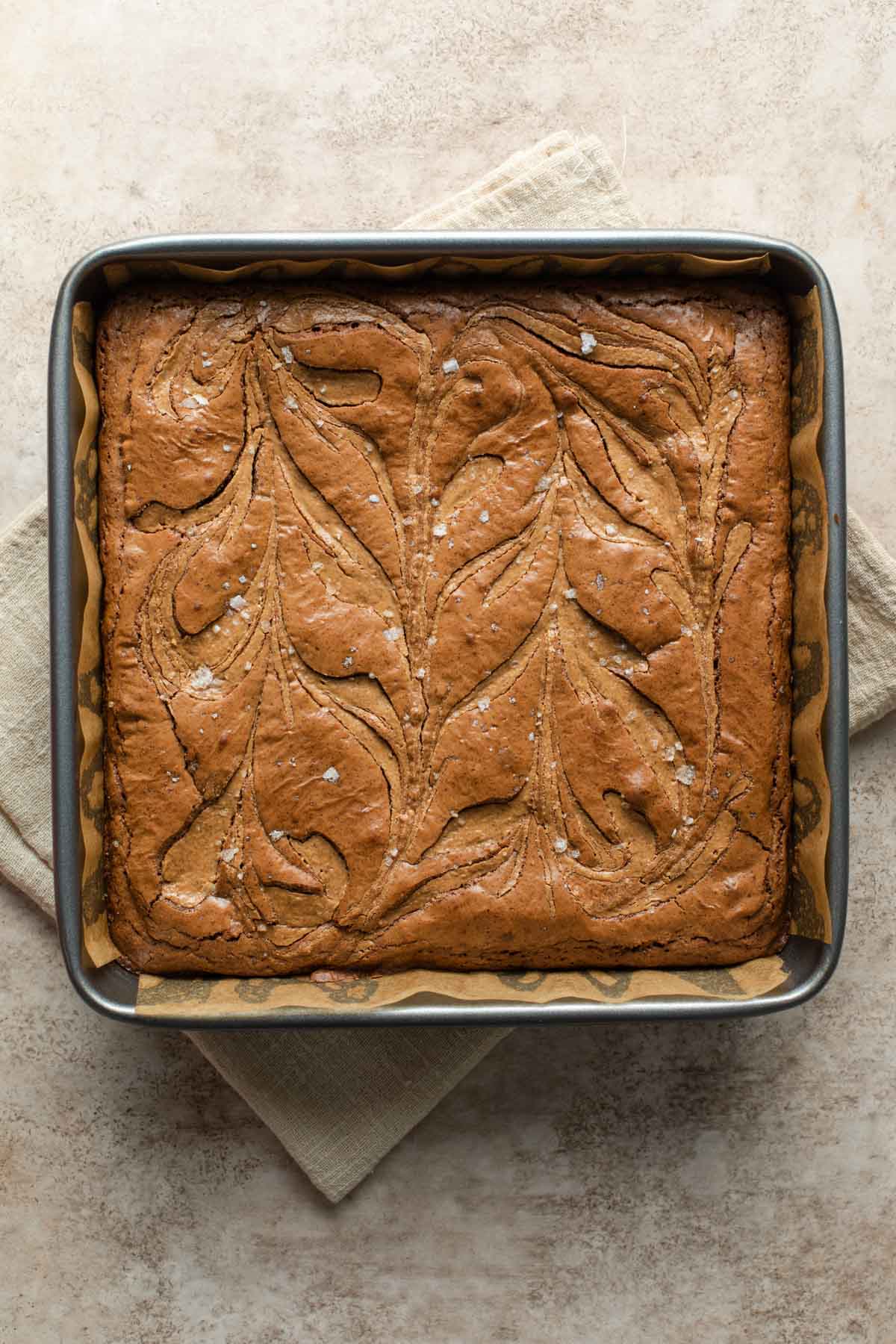 Almond butter brownies baked up in a square pan.