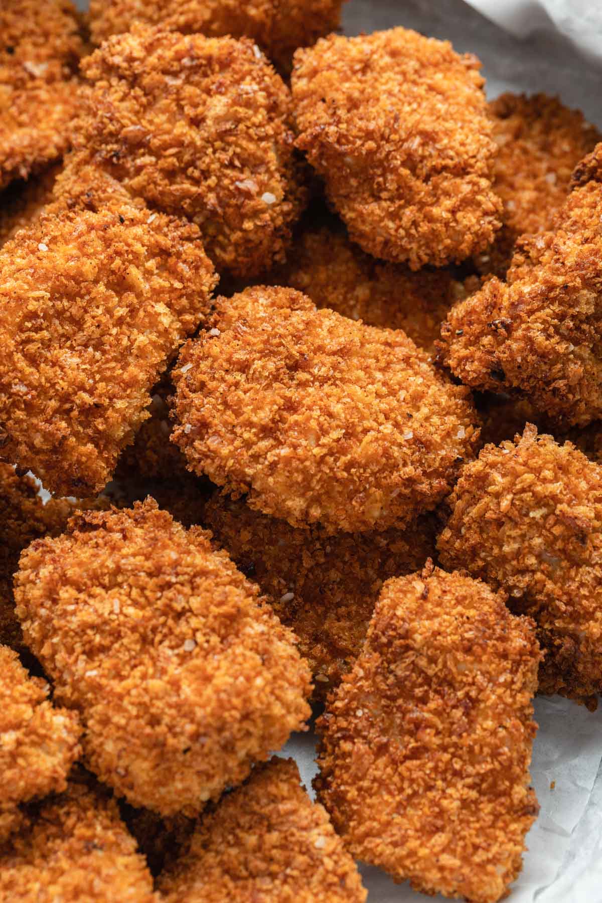 Overhead view of air fryer chicken bites arranged closely together.
