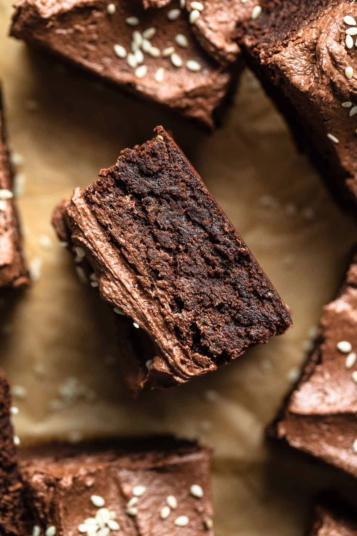 Up close view of a brownie on its side showing the fudgy texture.