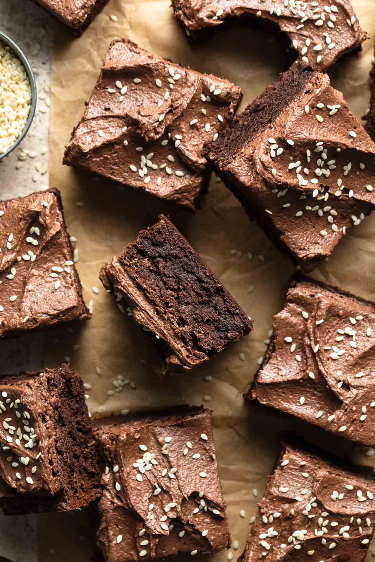 Tahini brownies arranged on brown parchment paper.