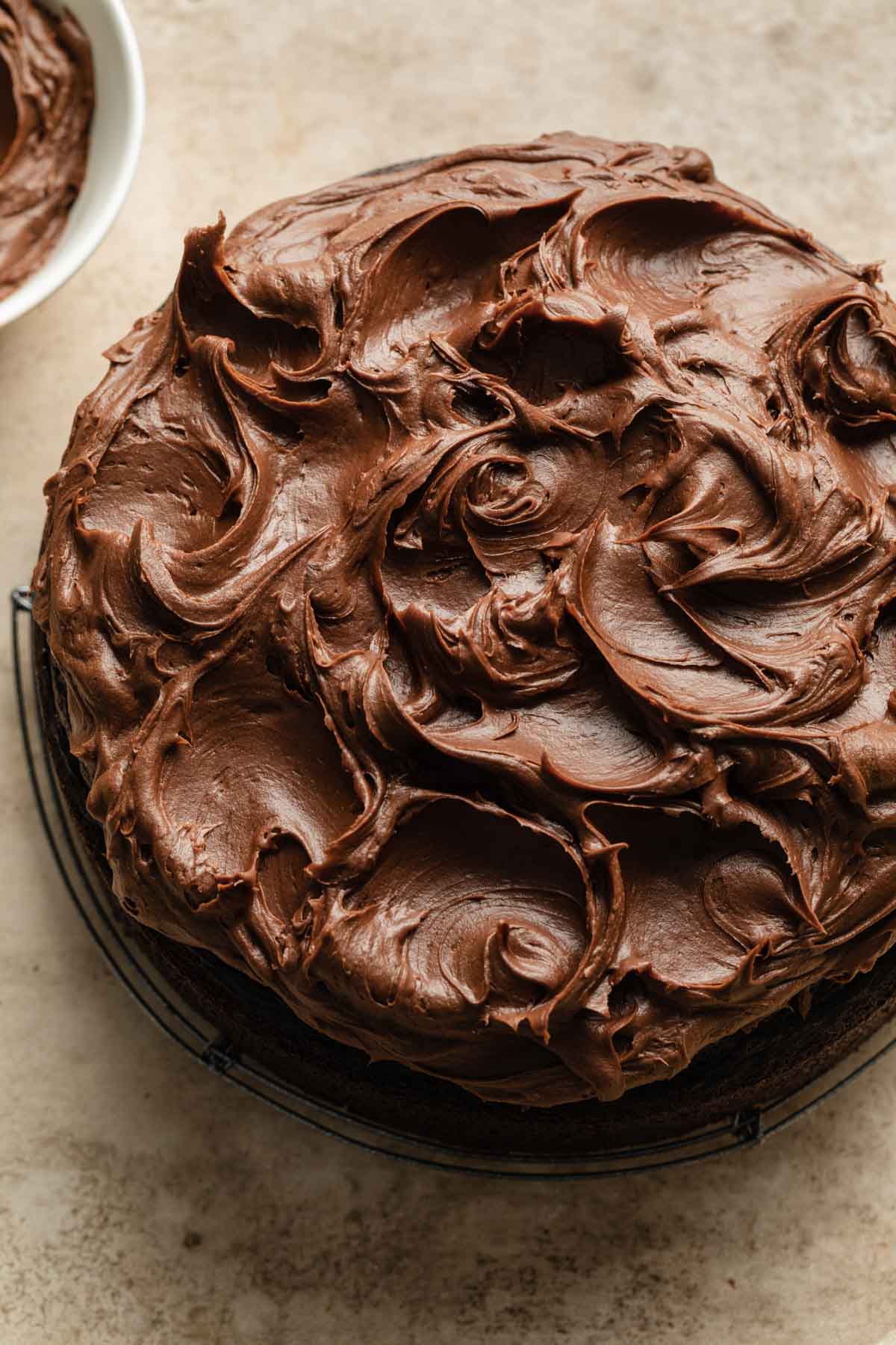 Overhead view of the chocolate frosting swirls on top of the air fryer chocolate cake.