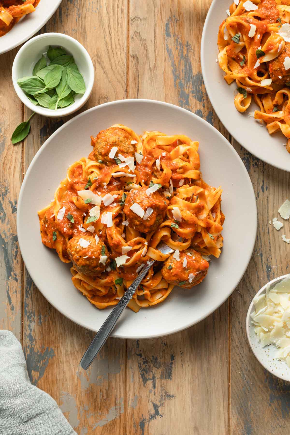 Turkey meatballs tossed with pasta and sauce on a plate.