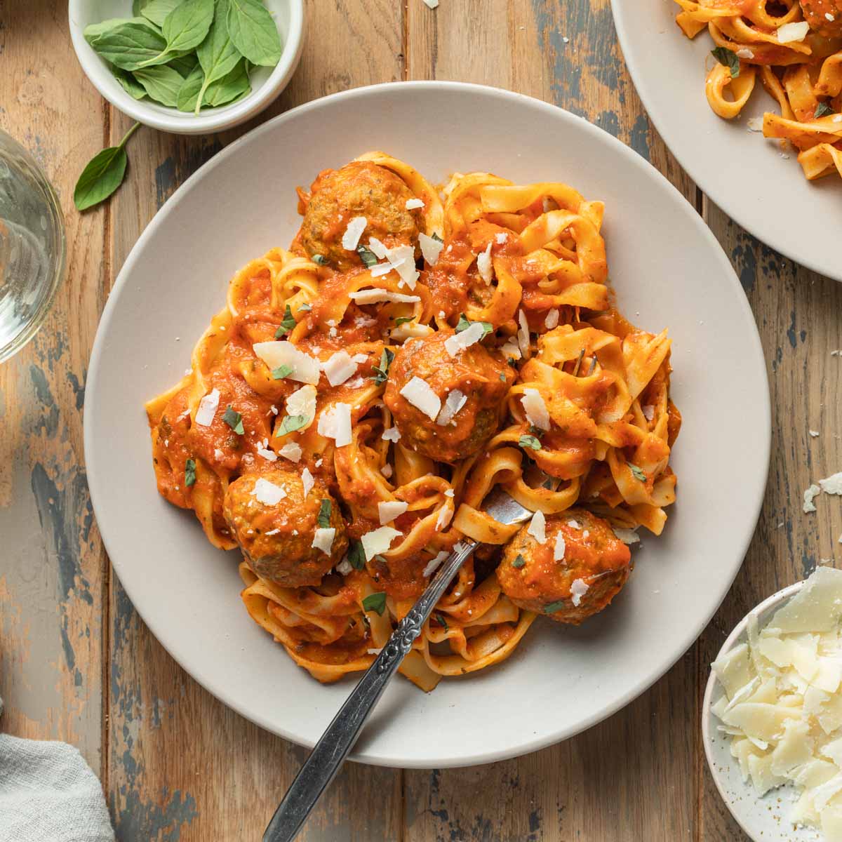 Air fryer turkey meatballs served on a plate with marinara sauce and pasta.