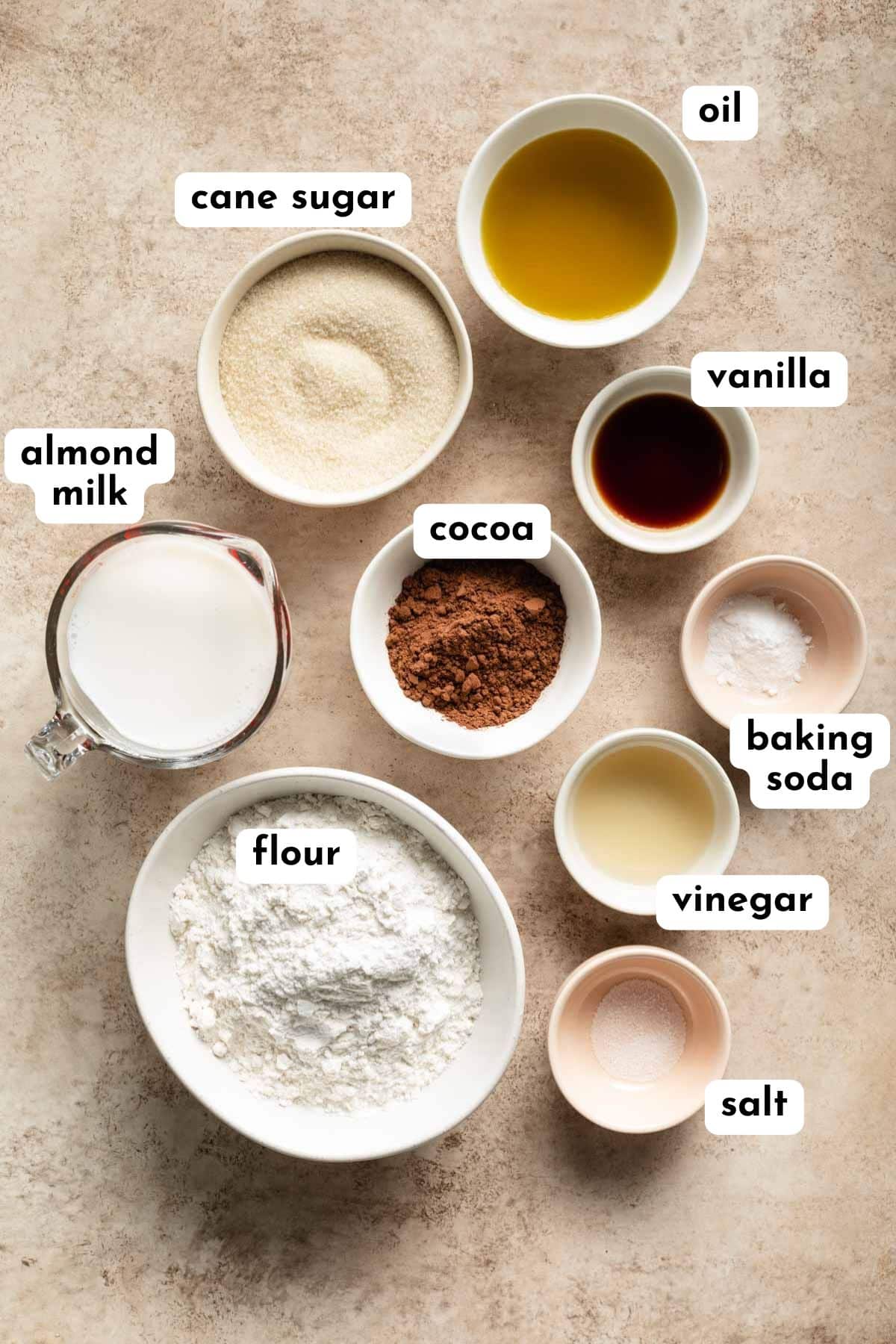 Air fryer cake ingredients arranged in individual dishes and labeled.