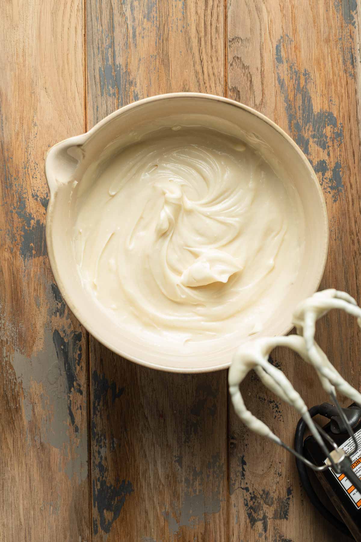 Overhead view of cream cheese frosting in a bowl.