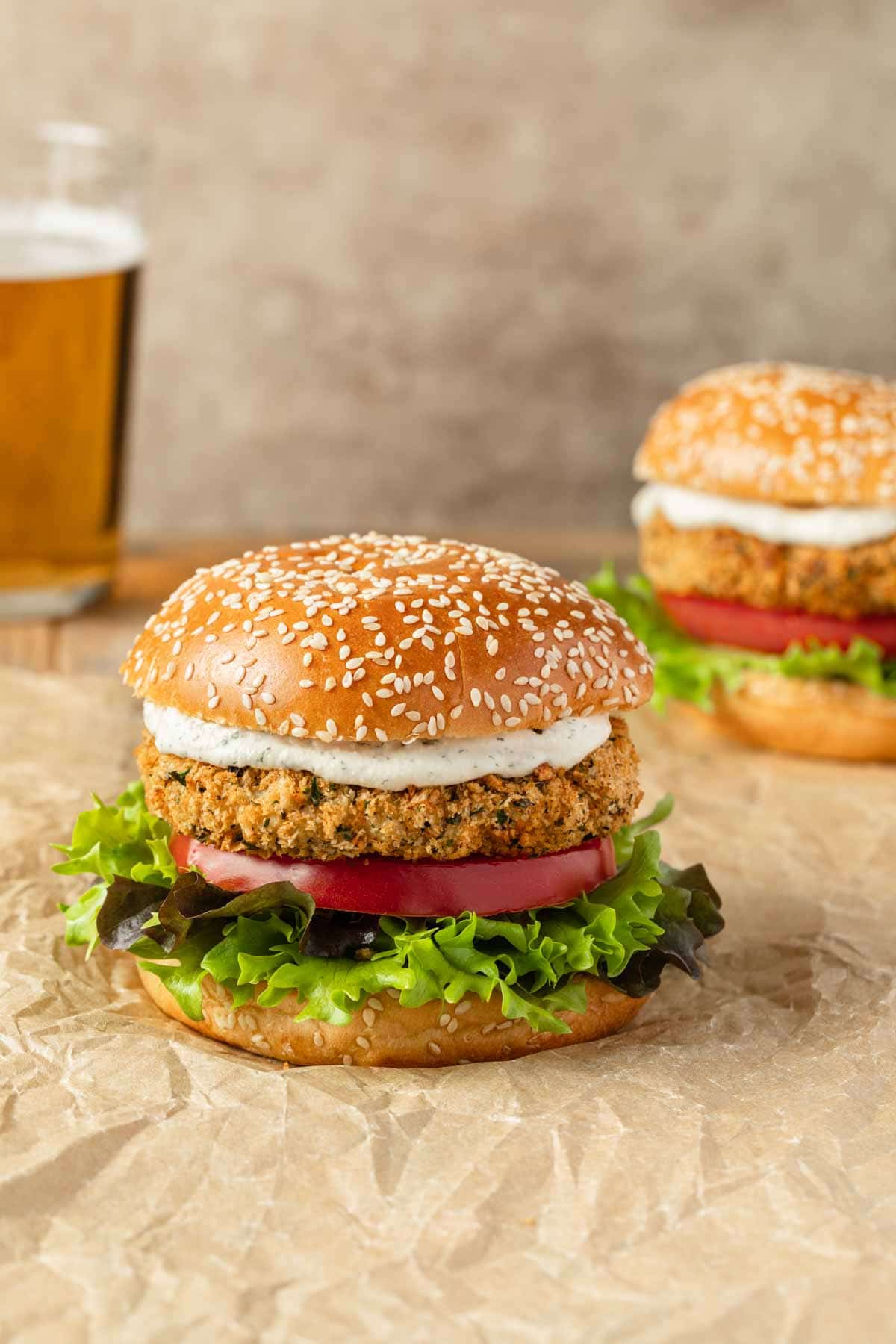 Air fryer chicken burgers assembled and arranged on brown parchment paper.