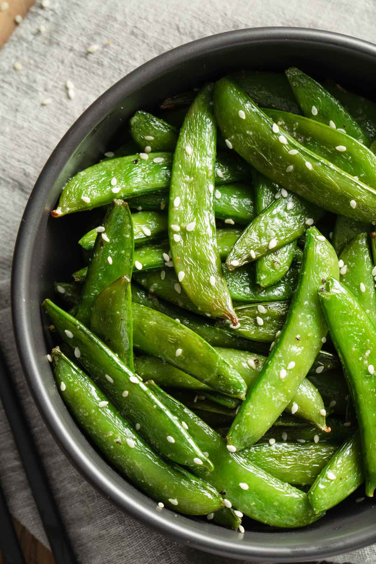 Close up view of air fryer roasted snap peas.
