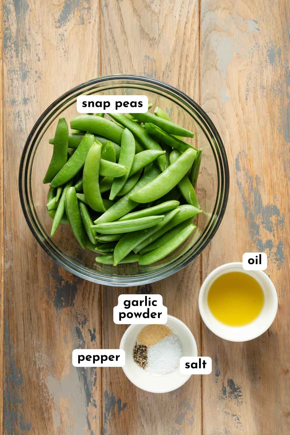 Ingredients to make air fried snap peas arranged individually and labeled.