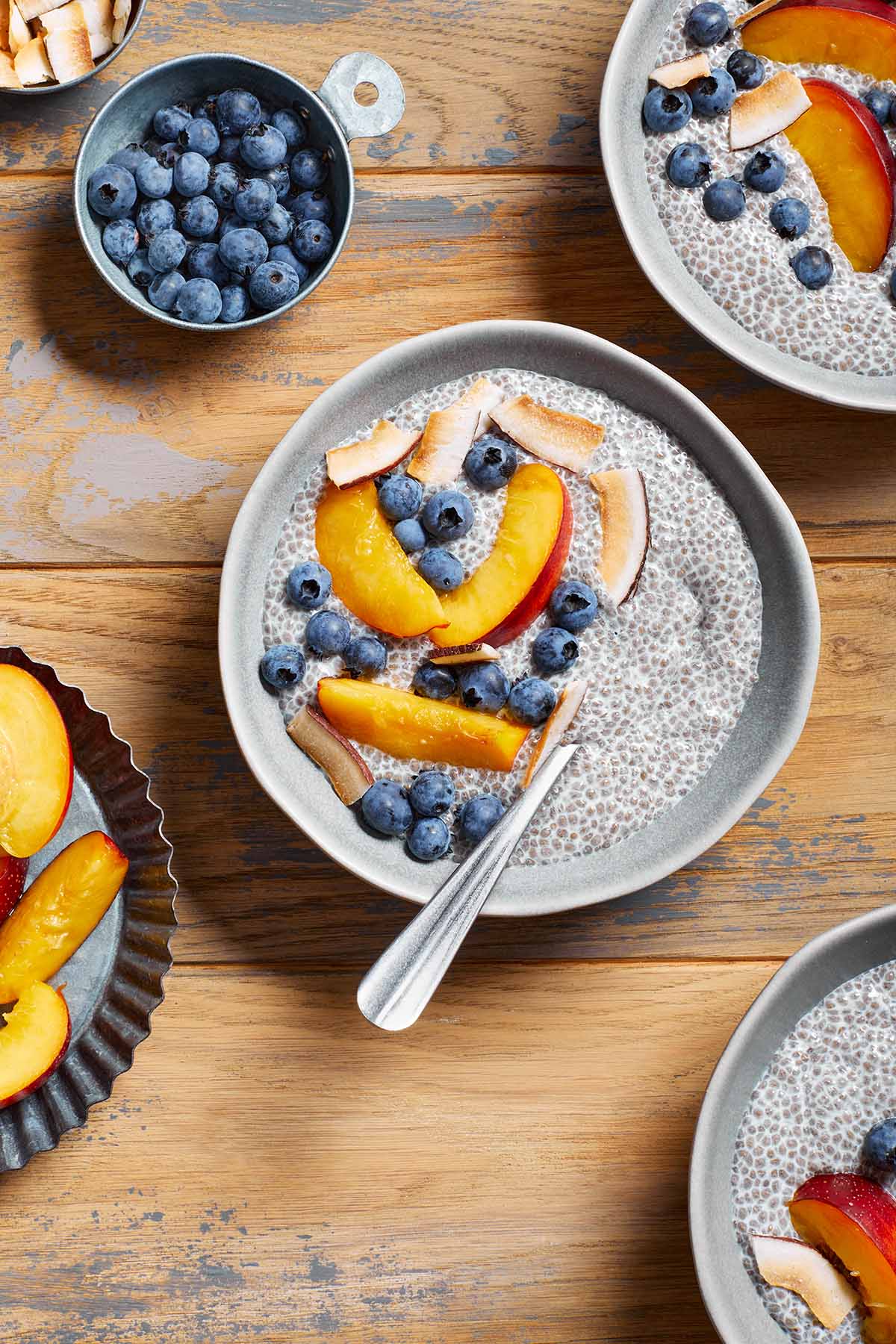 Overhead view of bowls of chia pudding topped with fruit.
