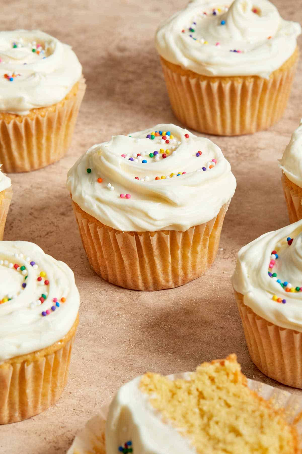 Three-quarter view of almond flour cupcakes arranged on a surface.