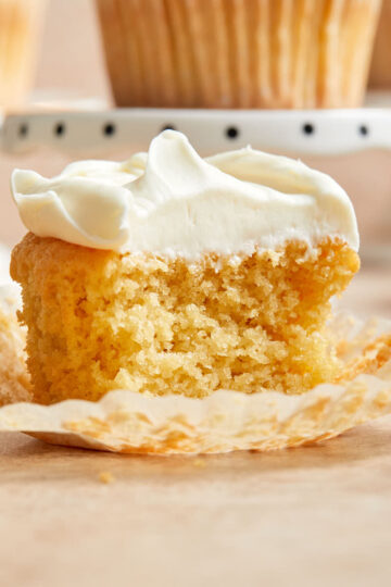 Side view of half an almond flour cupcake on a cupcake liner.