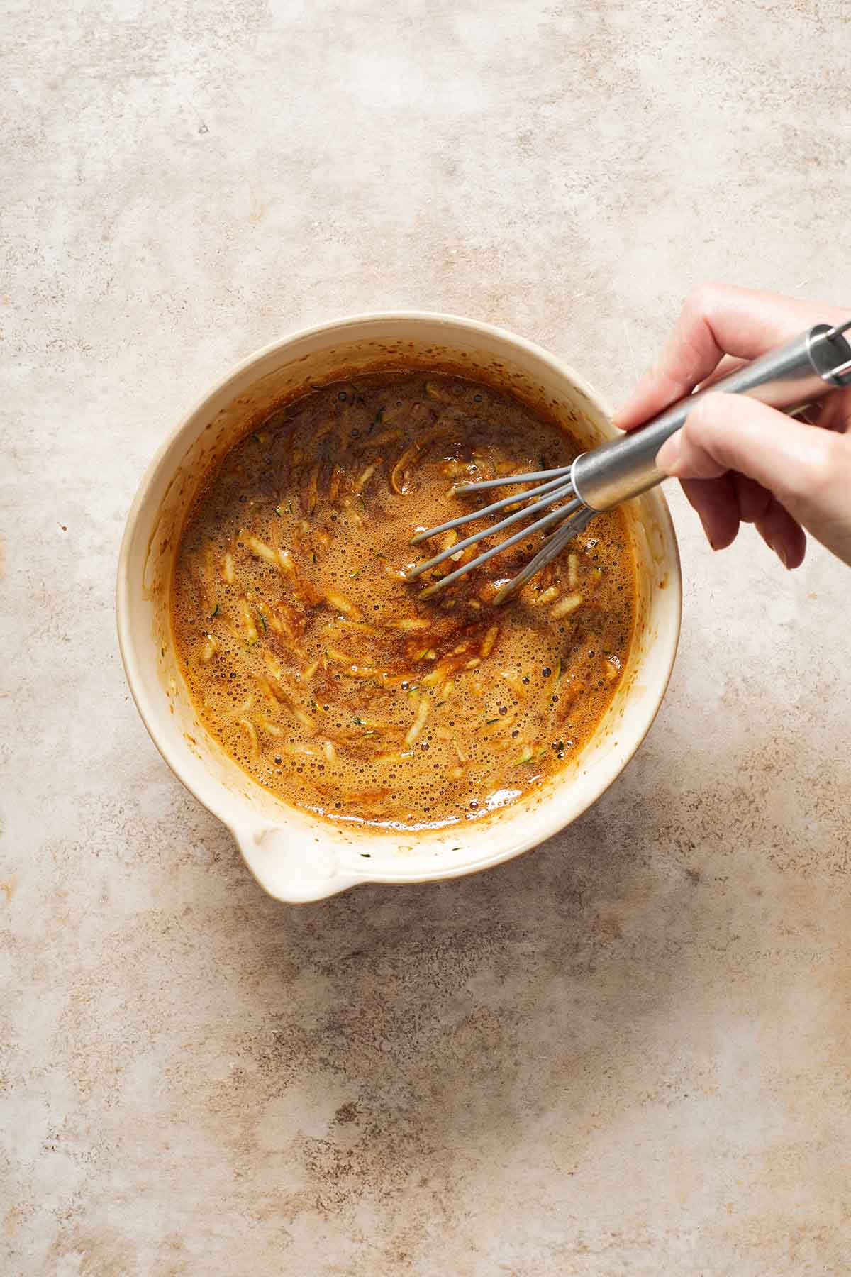 Grated zucchini whisked into the wet ingredients.