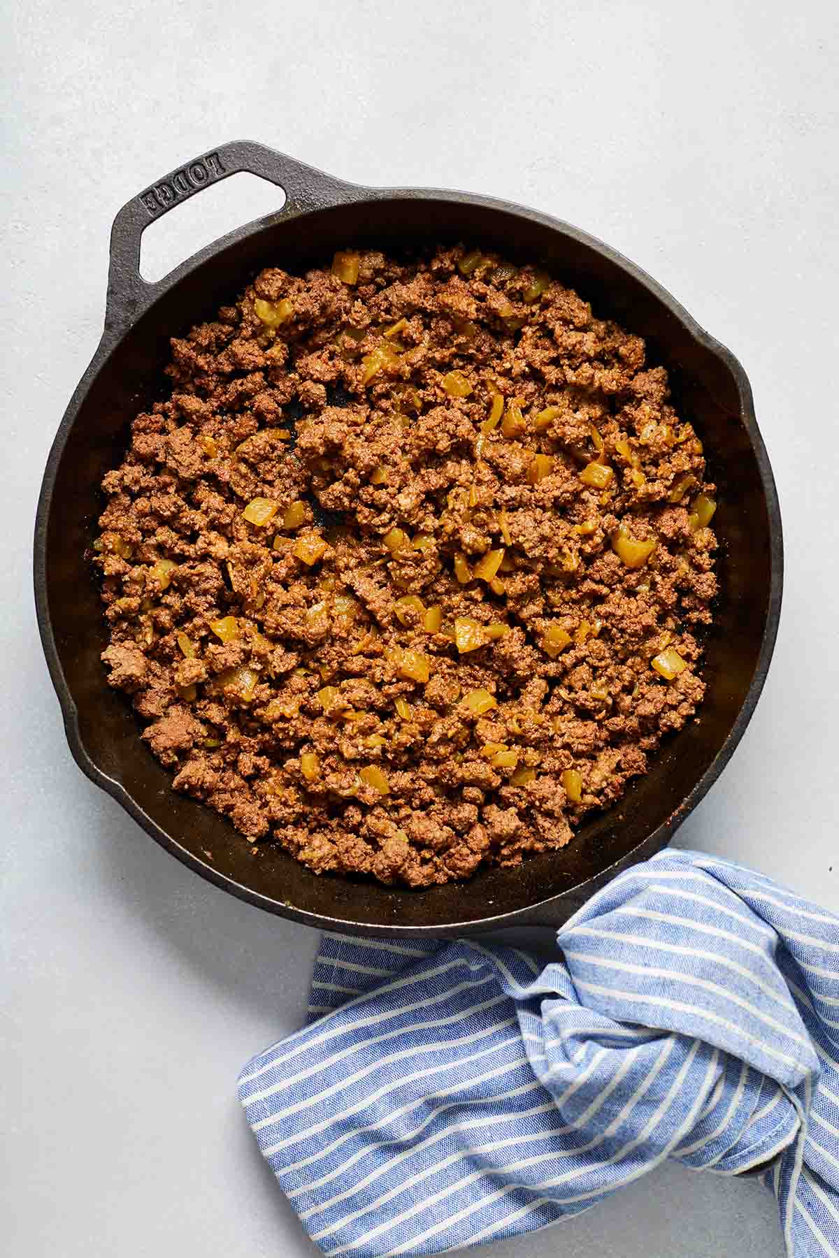 Ground beef mixture for fajitas in a black cast iron skillet.