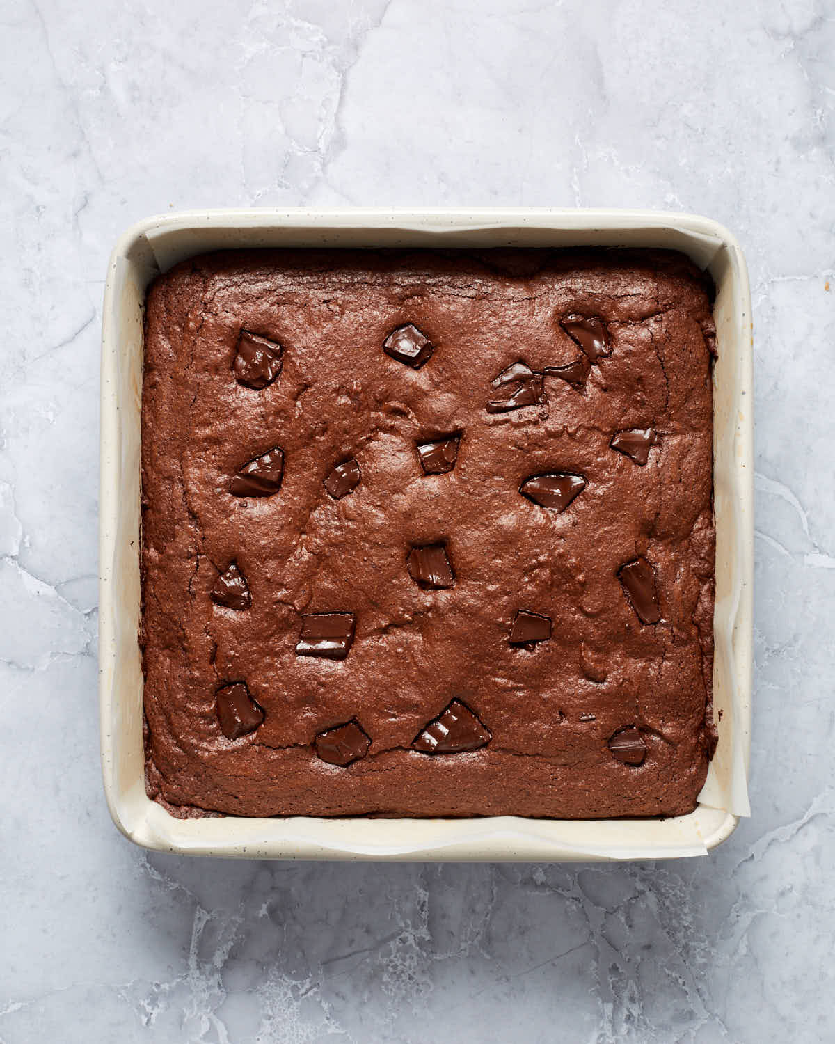 Uncut brownies in a square baking pan.