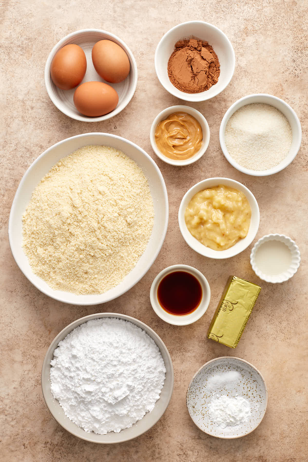 Ingredients to make almond flour banana cake arranged in individual bowls.