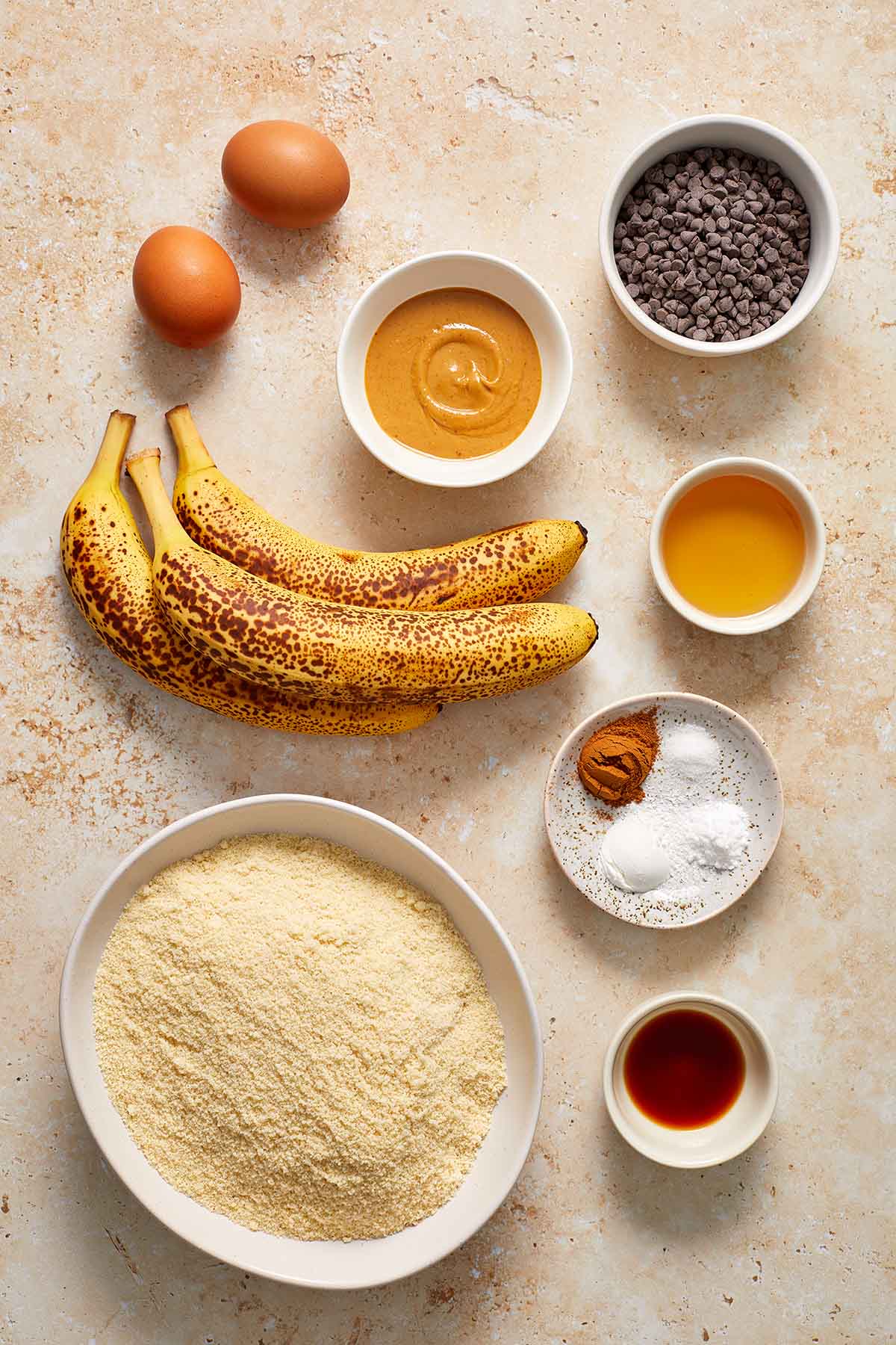 Ingredients to make almond flour banana muffins arranged individually.
