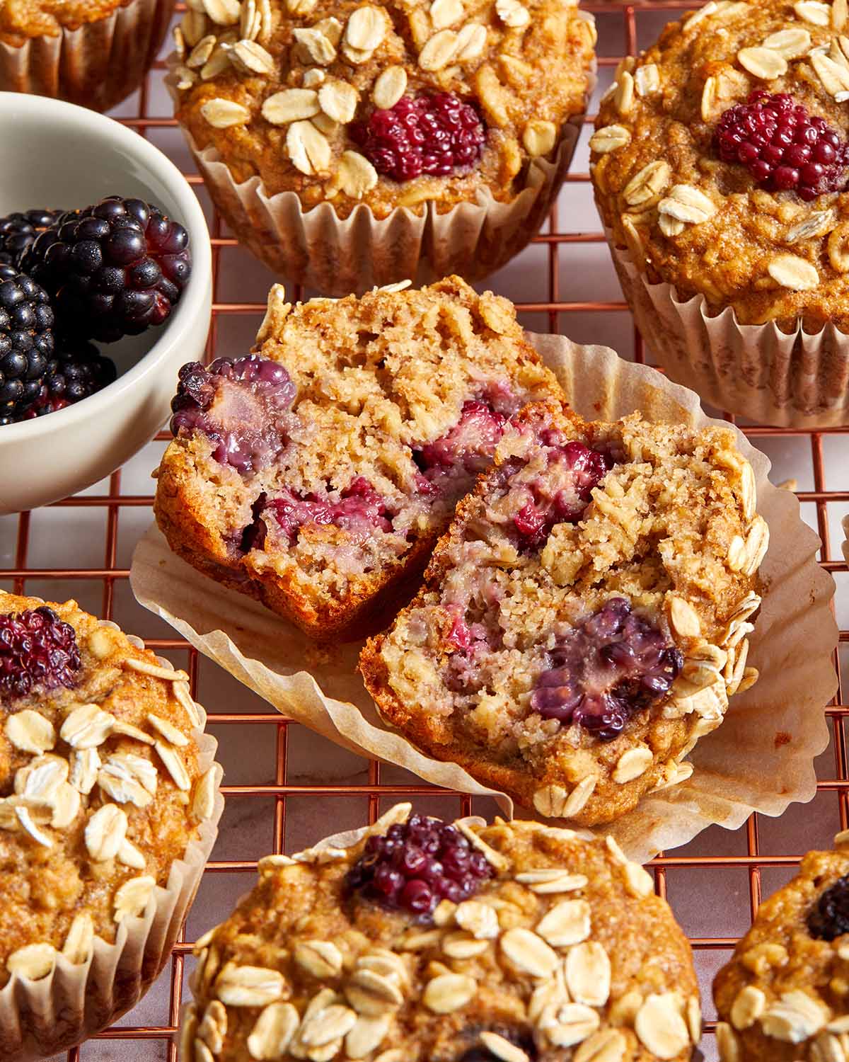 Muffin cut open showing the inside texture and blackberries.