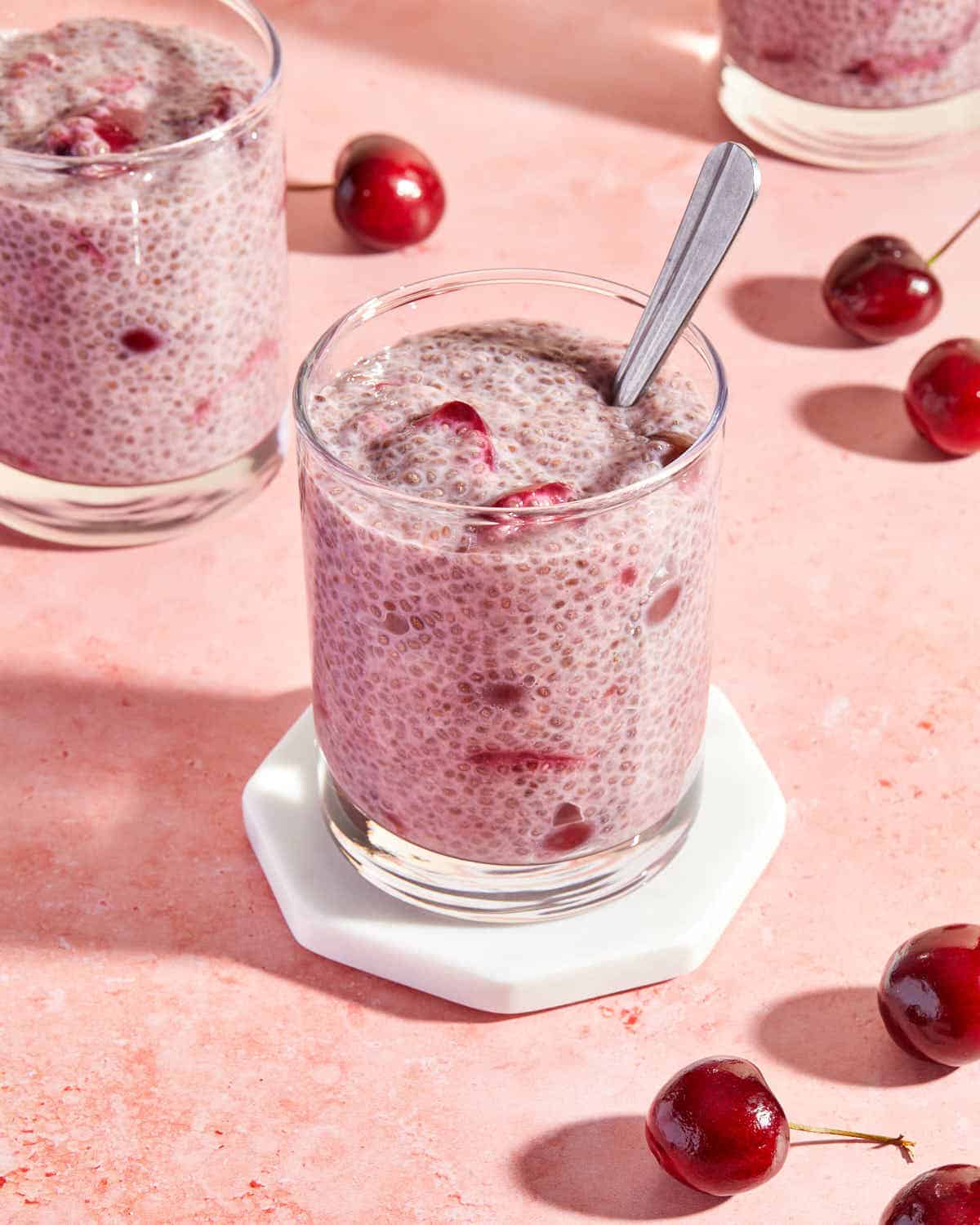 Chia pudding with fresh cherries served in glasses.