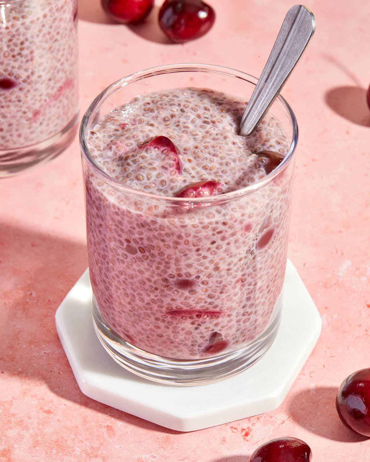 Close up view of chia pudding with cherry compote mixed throughout.