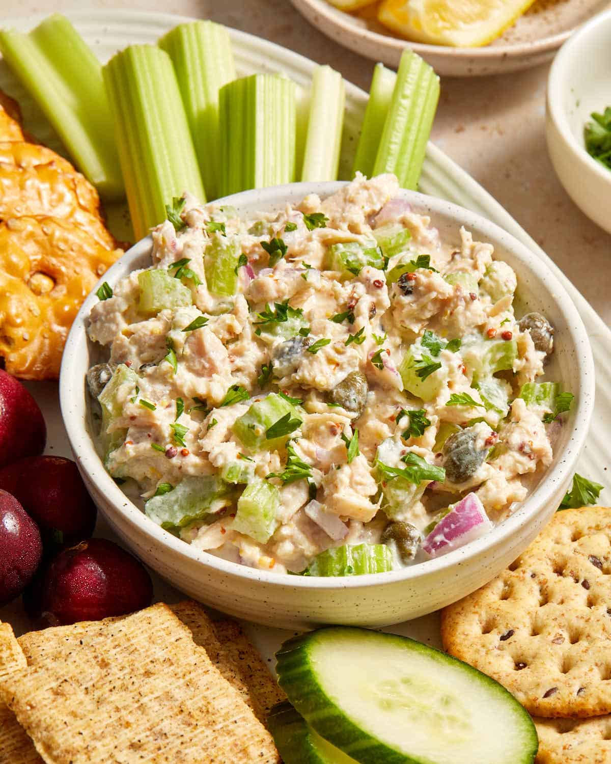 Side view of tuna salad in a small bowl on a platter.