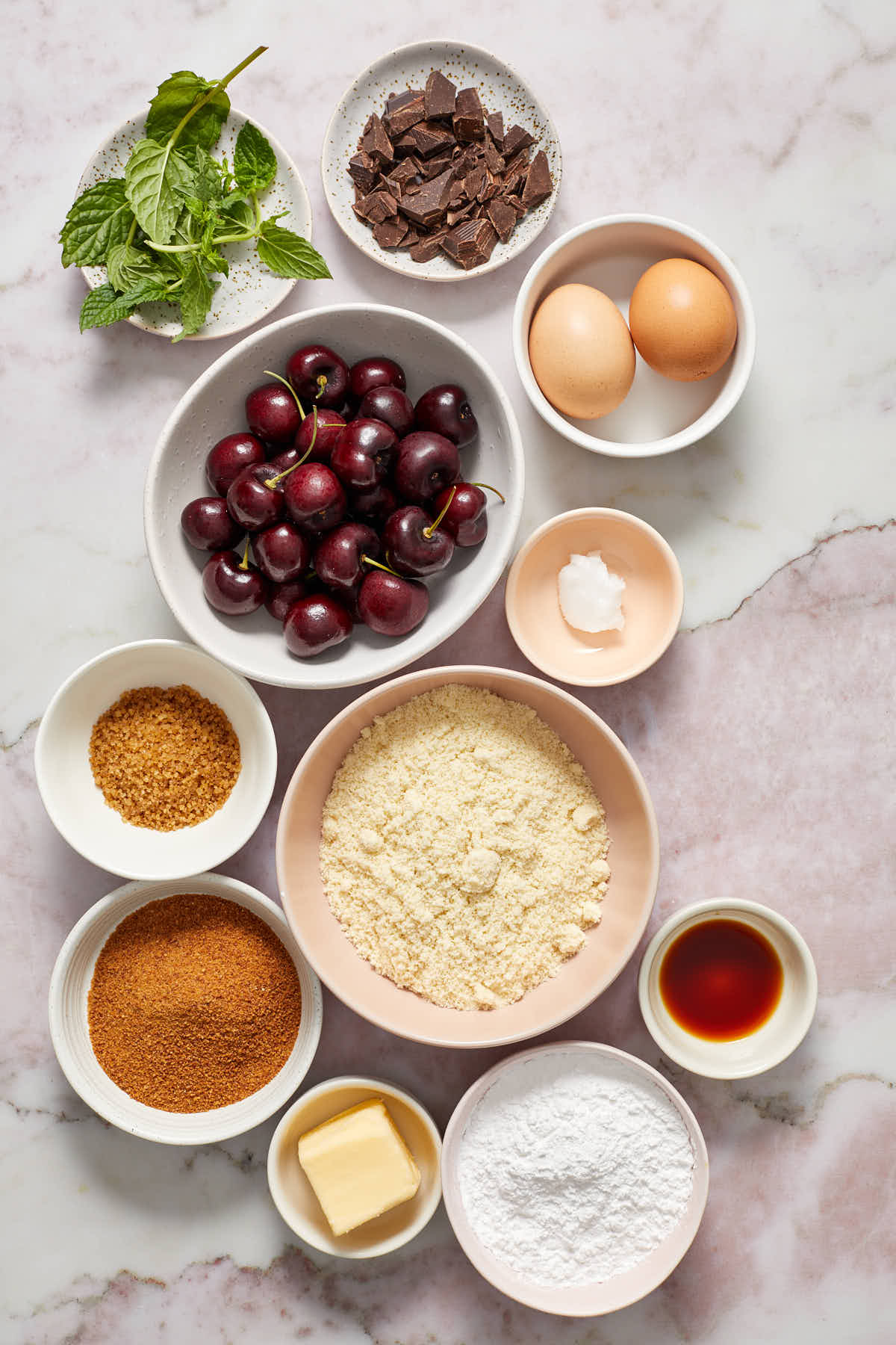 Ingredients to make an almond flour cherry galette arranged in individual bowls.