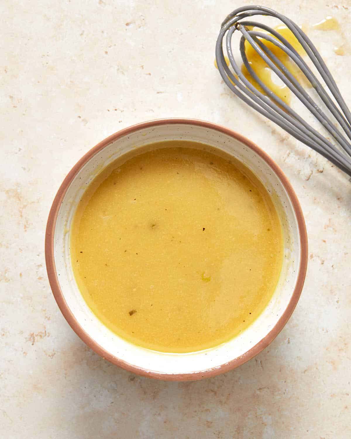 Dijon mustard dressing in a small bowl.