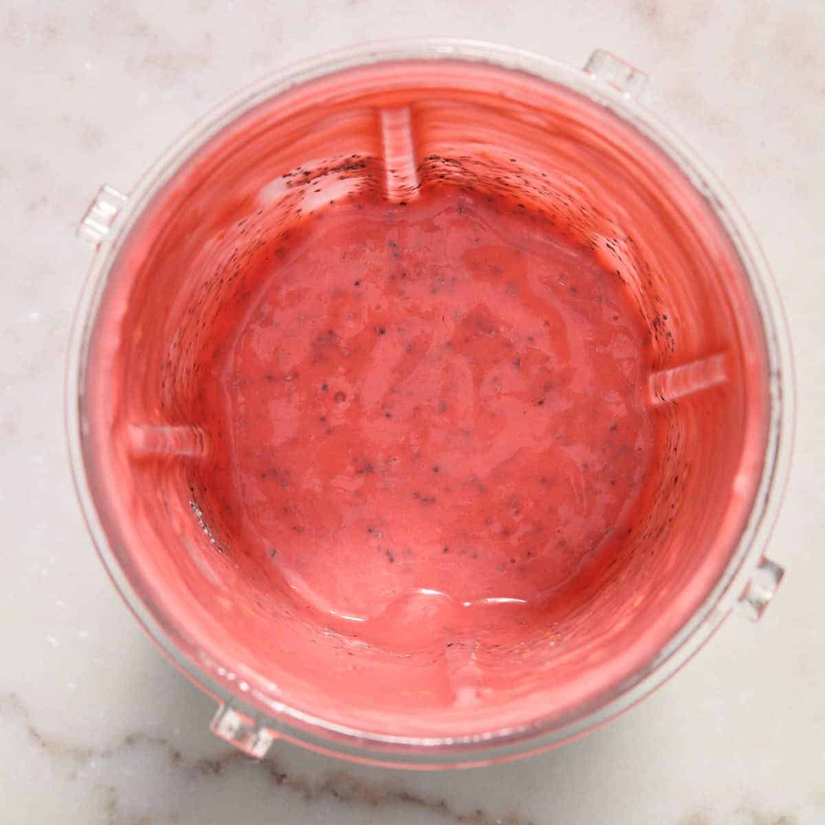 Poppy seeds stirred in to the dressing in the cup.