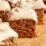 Close up view of a piece of banana cake topped with cinnamon cream cheese frosting.