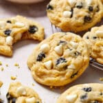 Close up view of a blueberry lemon cookie surrounded by other cookies.