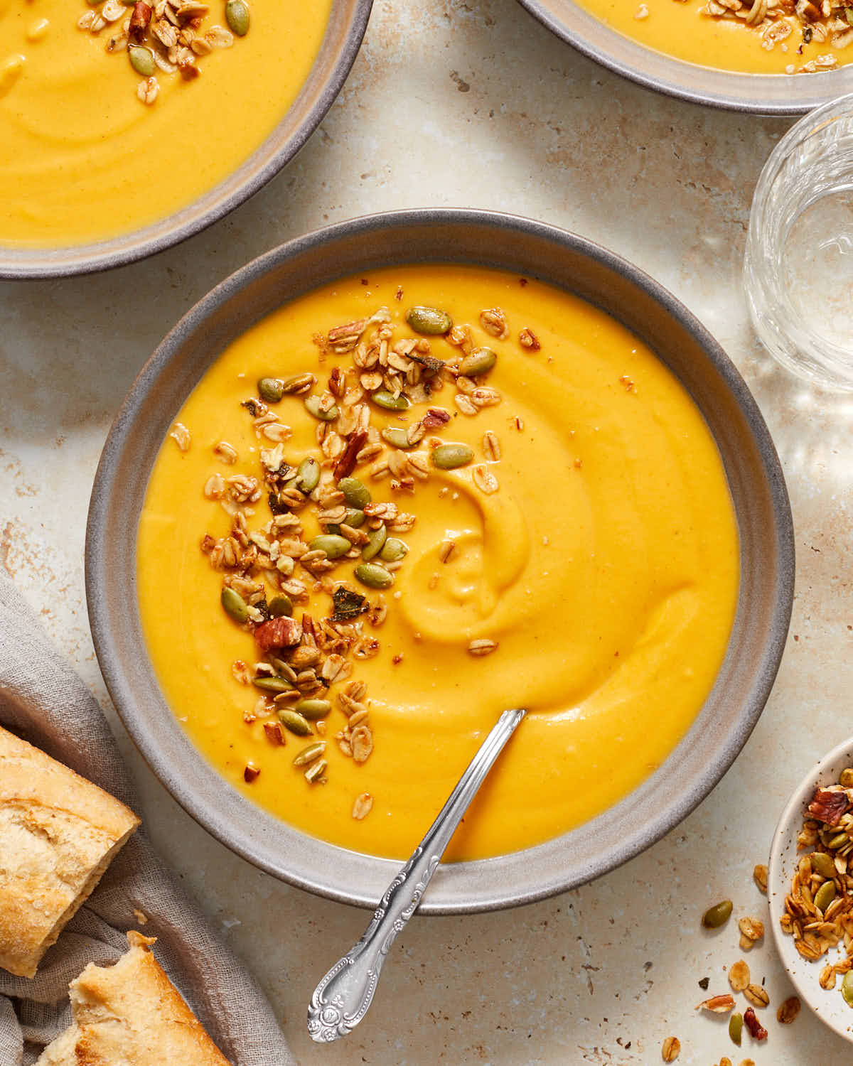 Overhead of bowls of carrot butternut squash soup.